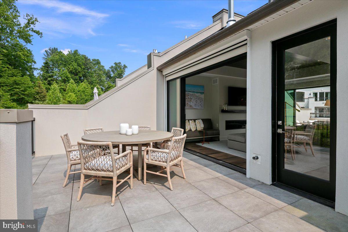 8129 River Road Bethesda, MD 20817 - Photo 57 of 84 a patio with table and chairs