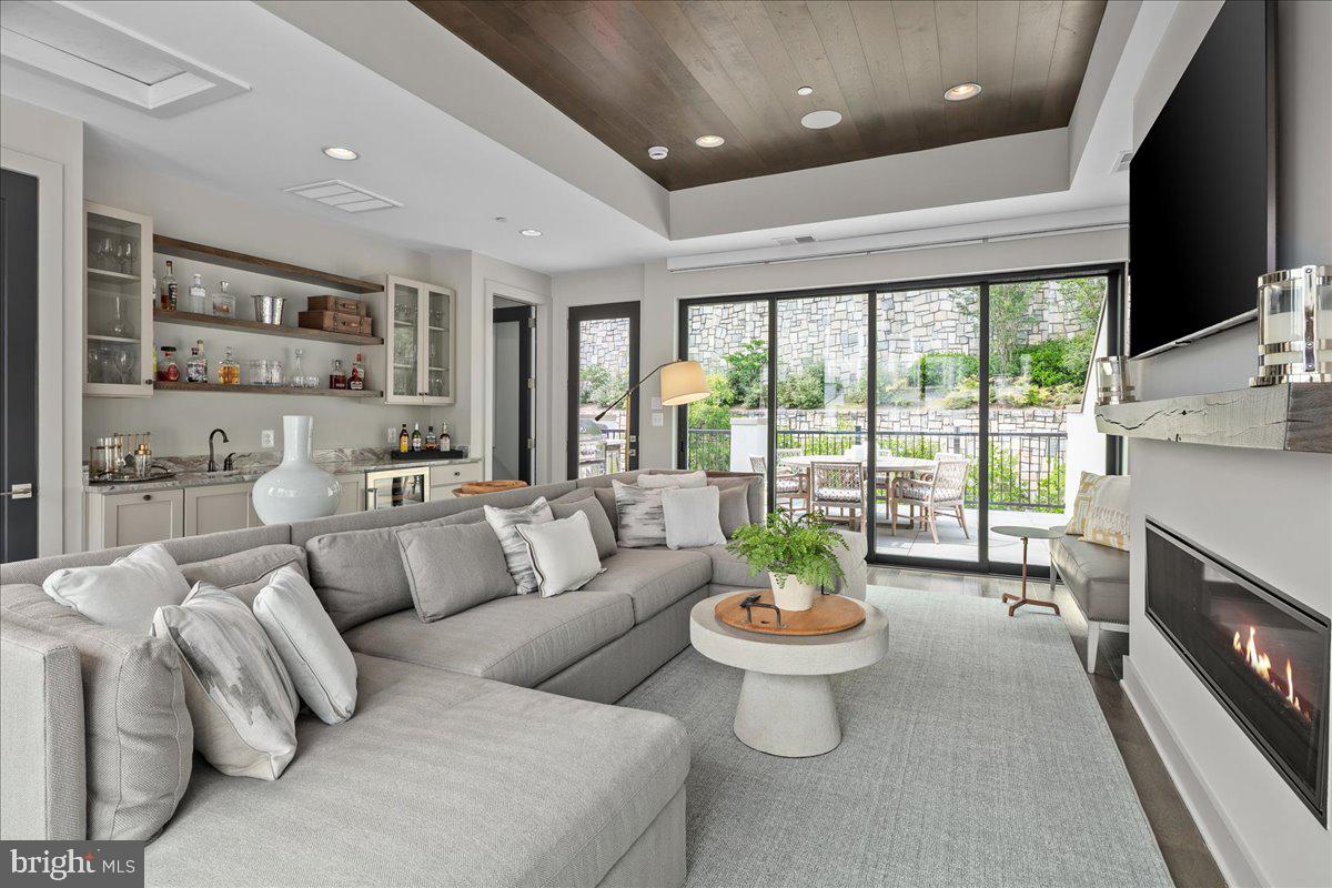 8129 River Road Bethesda, MD 20817 - Photo 60 of 84 a living room with furniture a flat screen tv and a large window