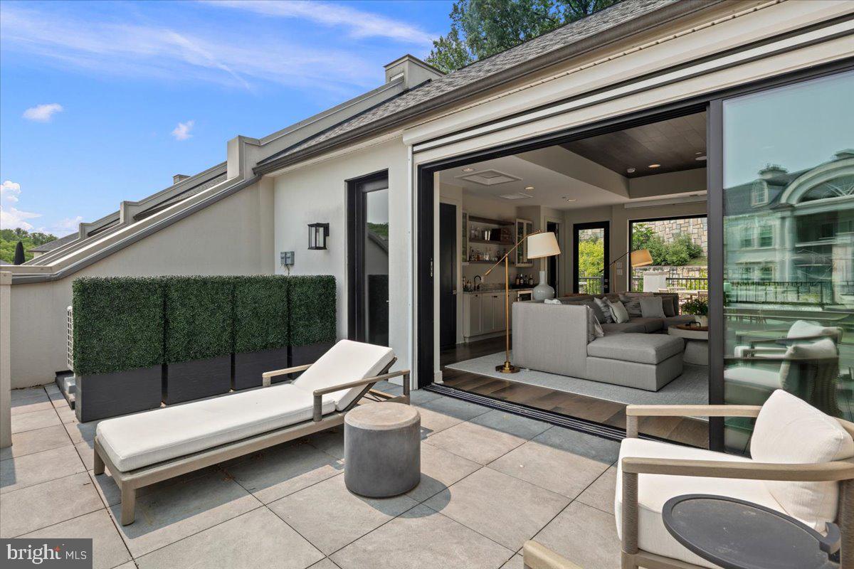 8129 River Road Bethesda, MD 20817 - Photo 67 of 84 a view of a patio with couches and potted plants