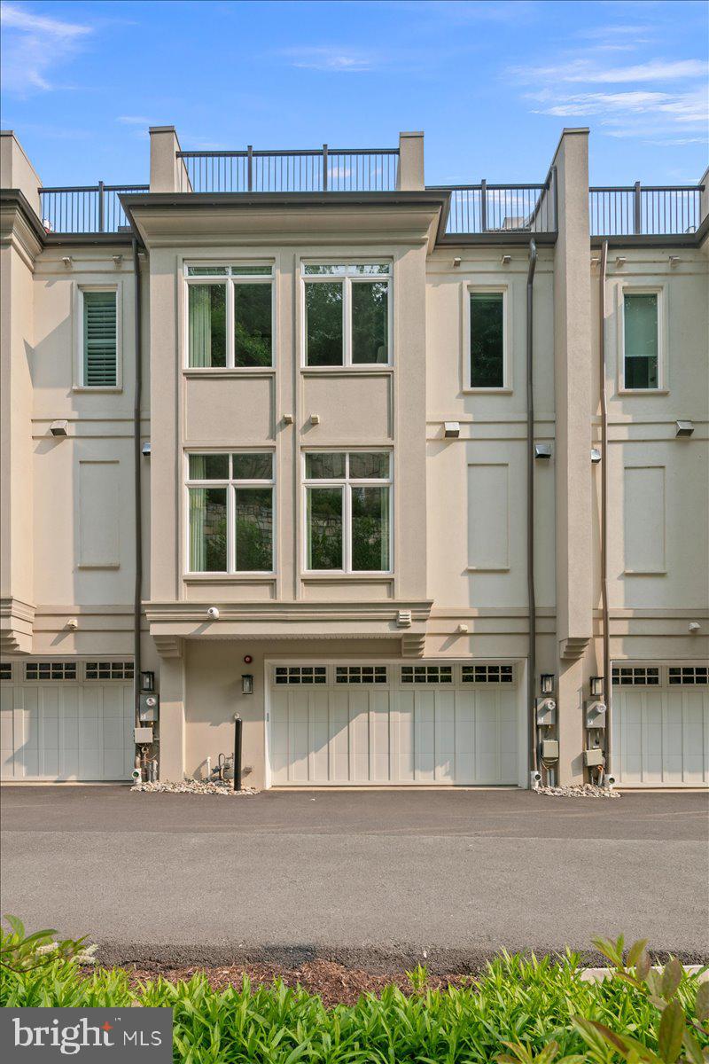 8129 River Road Bethesda, MD 20817 - Photo 69 of 84 a front view of a house with a yard and garage