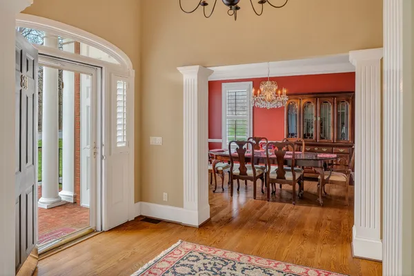 a view of a dining room with furniture and chandelier