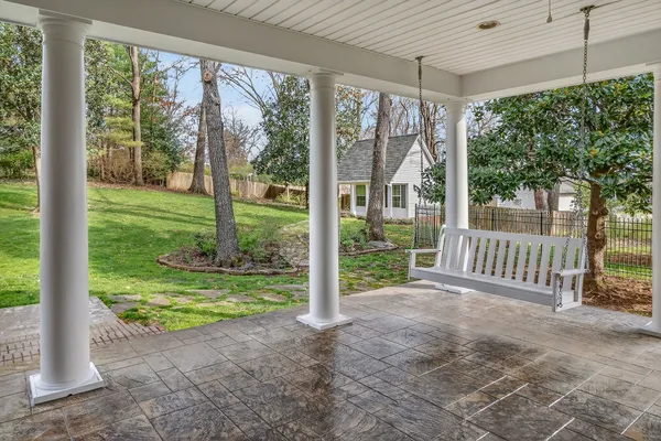 a view of a back yard of the house with green space