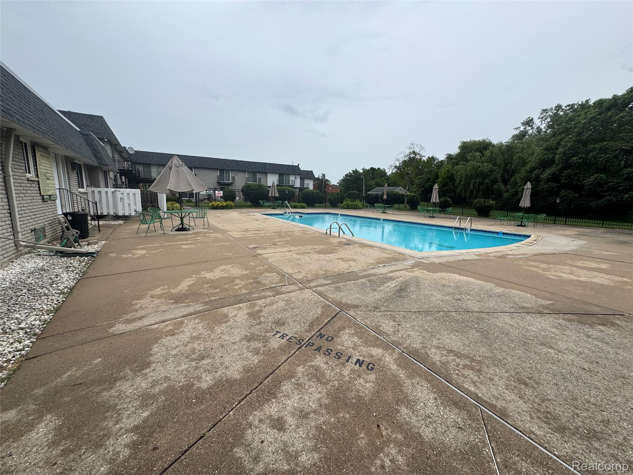 4386 15 Mile Road, Unit 64 Sterling Heights, MI 48310 - Photo 19 of 23 Community swimming pool with concrete decking
