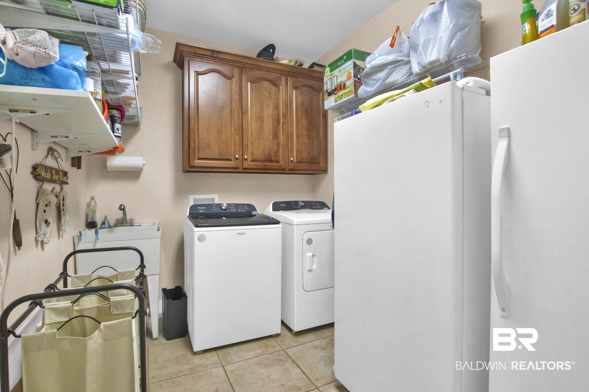 1 Bens Bluff Daphne, AL 36527 - Photo 31 of 56 Laundry room with light tile patterned floors, washing machine and clothes dryer, and cabinets