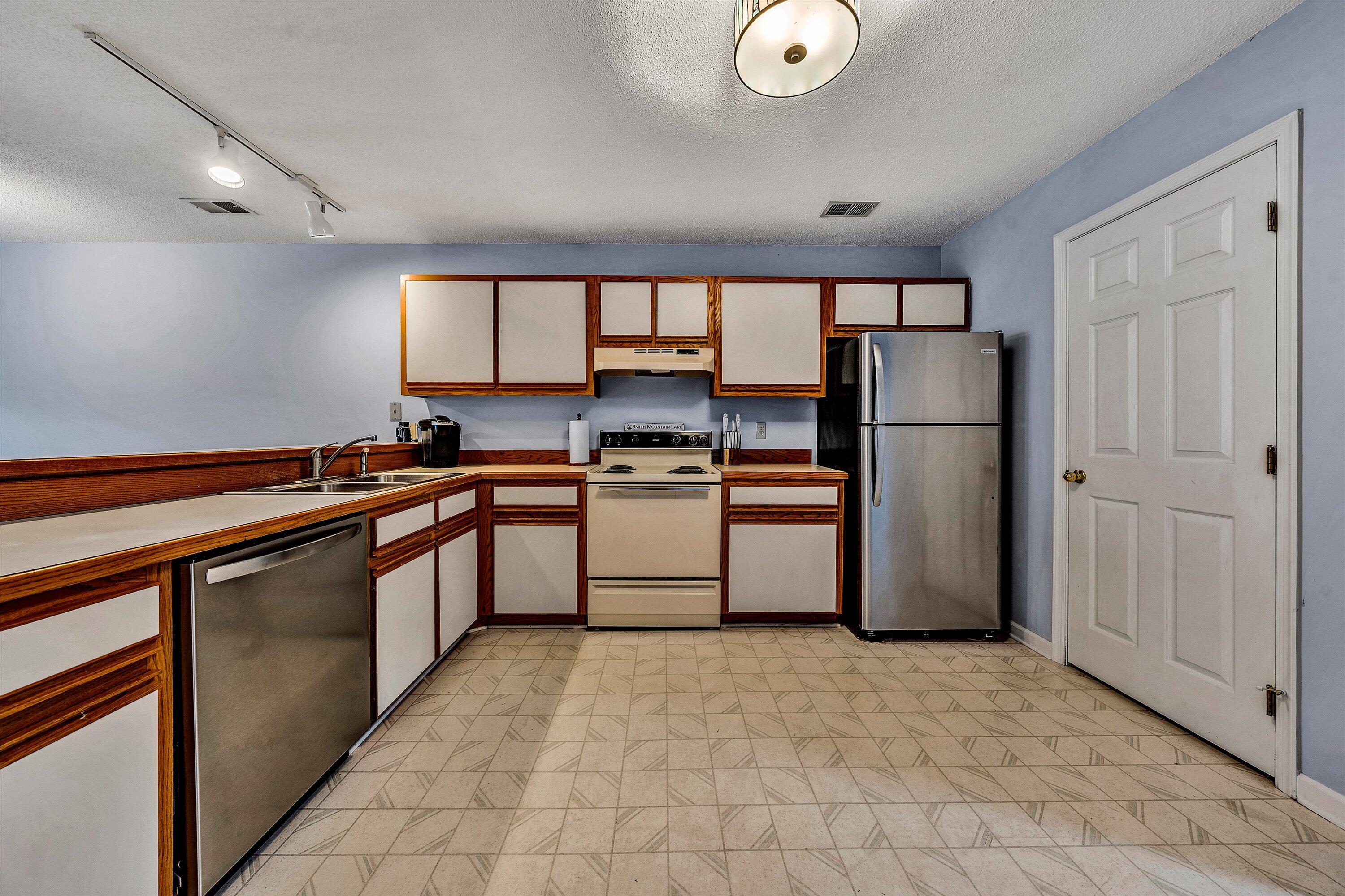 600 Monte Vista Road, Unit 802 Union Hall, VA 24176 - Photo 7 of 32 a kitchen with a refrigerator sink and cabinets