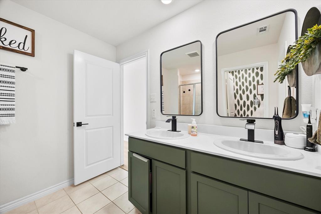 1003 Stage Coach Lane Princeton, TX 75407 - Photo 16 of 26 a bathroom with a double vanity sink mirror and