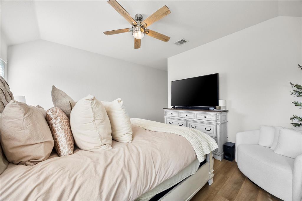 1003 Stage Coach Lane Princeton, TX 75407 - Photo 19 of 26 a bedroom with a bed and a flat screen tv