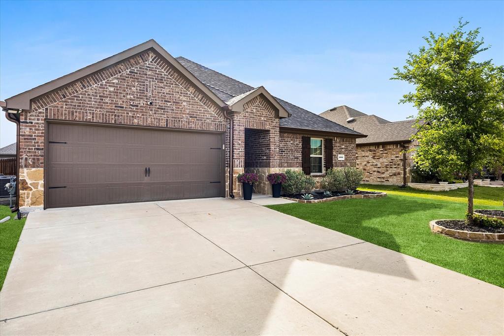 1003 Stage Coach Lane Princeton, TX 75407 - Photo 2 of 26 a front view of a house with garden