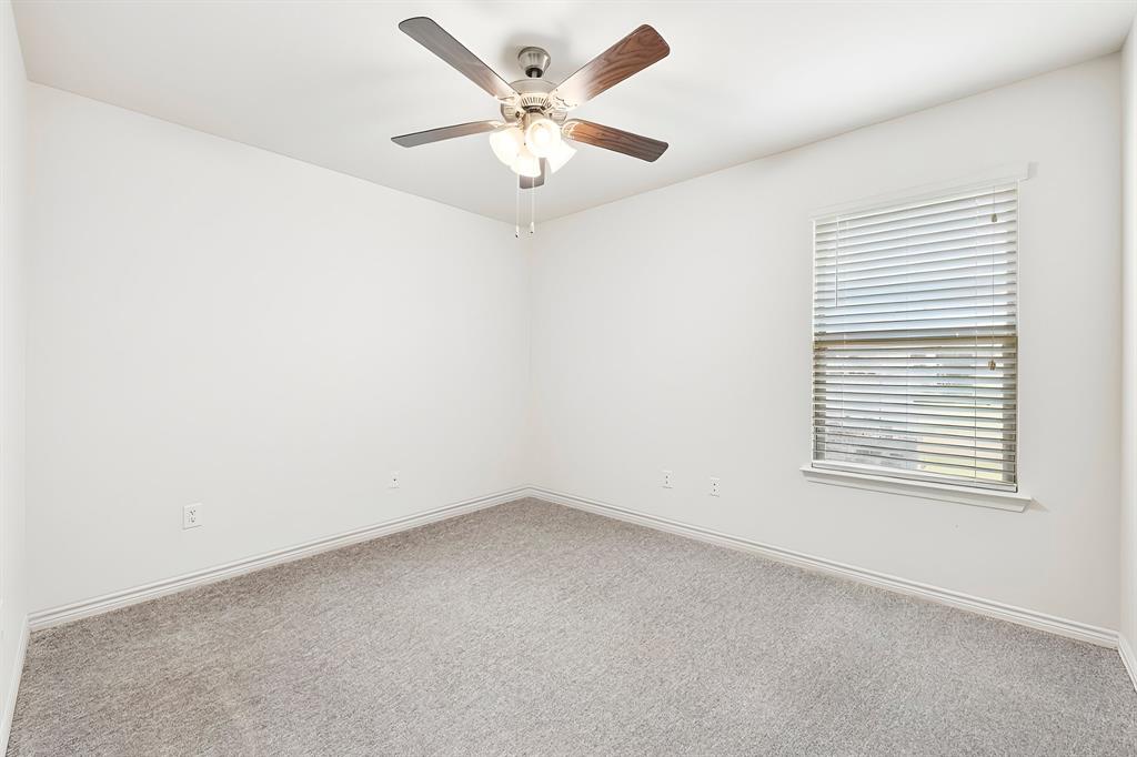 1003 Stage Coach Lane Princeton, TX 75407 - Photo 25 of 26 an empty room with a window and a ceiling fan