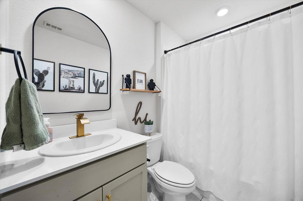 1003 Stage Coach Lane Princeton, TX 75407 - Photo 6 of 26 a bathroom with a sink toilet and mirror