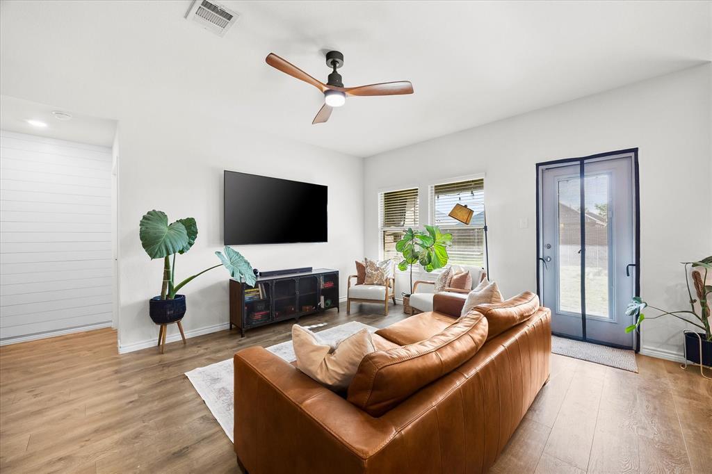 1003 Stage Coach Lane Princeton, TX 75407 - Photo 7 of 26 a living room with furniture and a flat screen tv