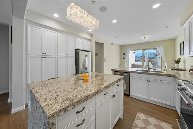 a bathroom with a granite countertop sink and a wooden cabinets