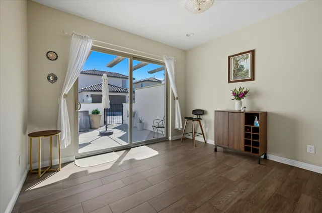 a view of a room with wooden floor and a ceiling fan