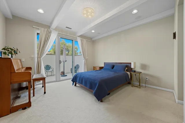 a spacious bedroom with a bed and a window