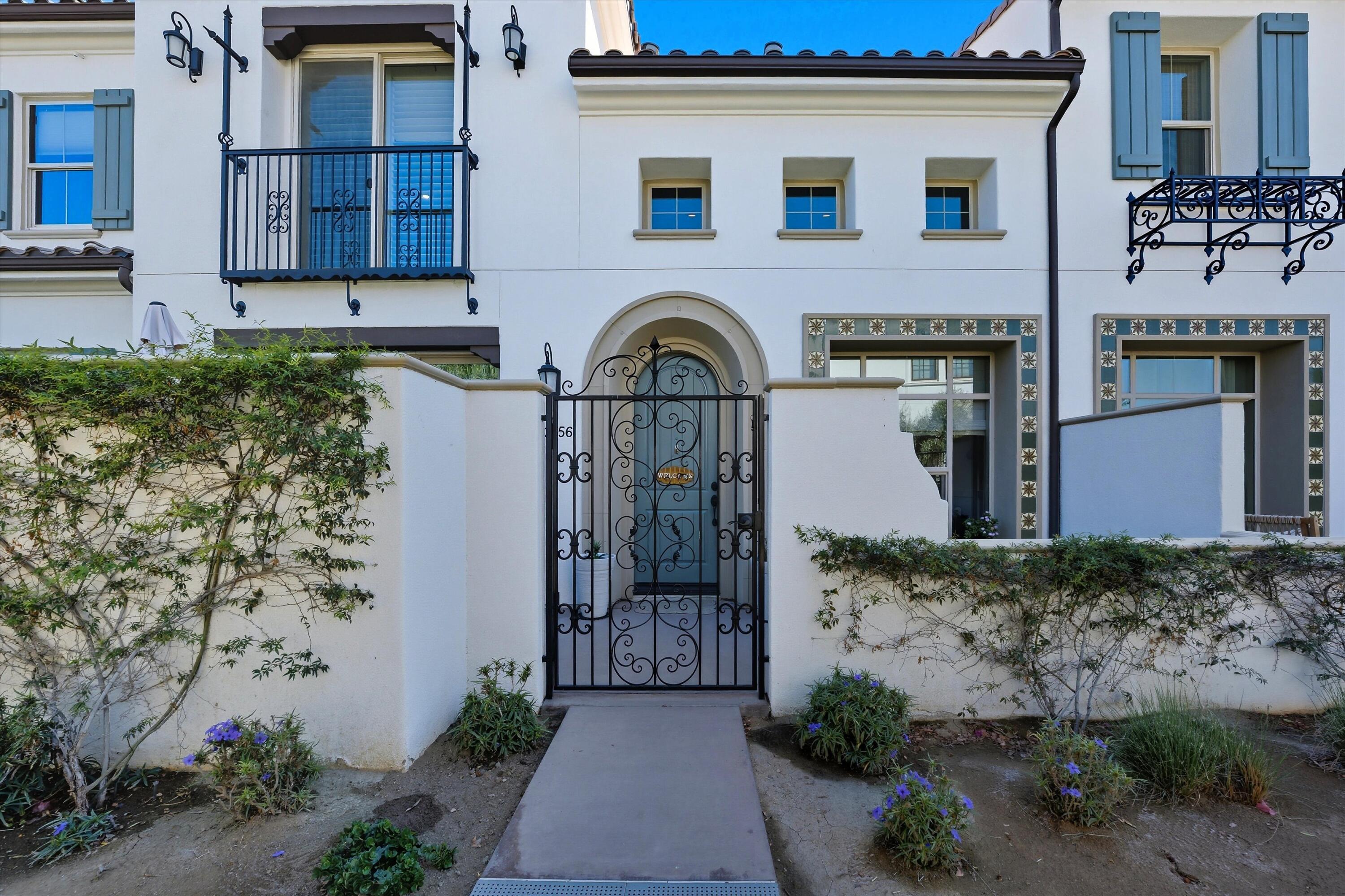 80256 Redstone Way, Unit V93 La Quinta, CA 92253 - Photo 2 of 37 a front view of a house with a garden