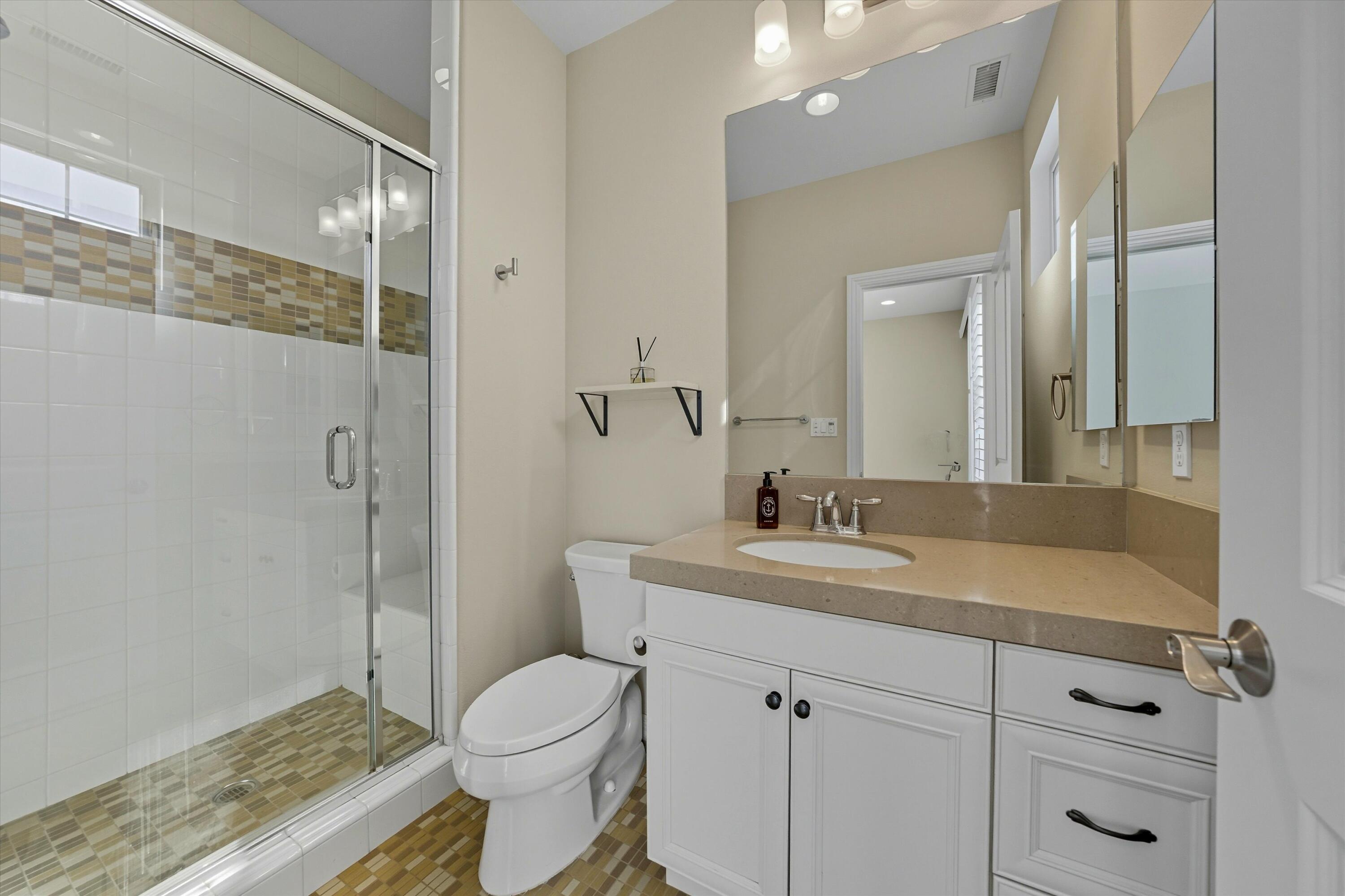 80256 Redstone Way, Unit V93 La Quinta, CA 92253 - Photo 23 of 37 a bathroom with a sink toilet and shower