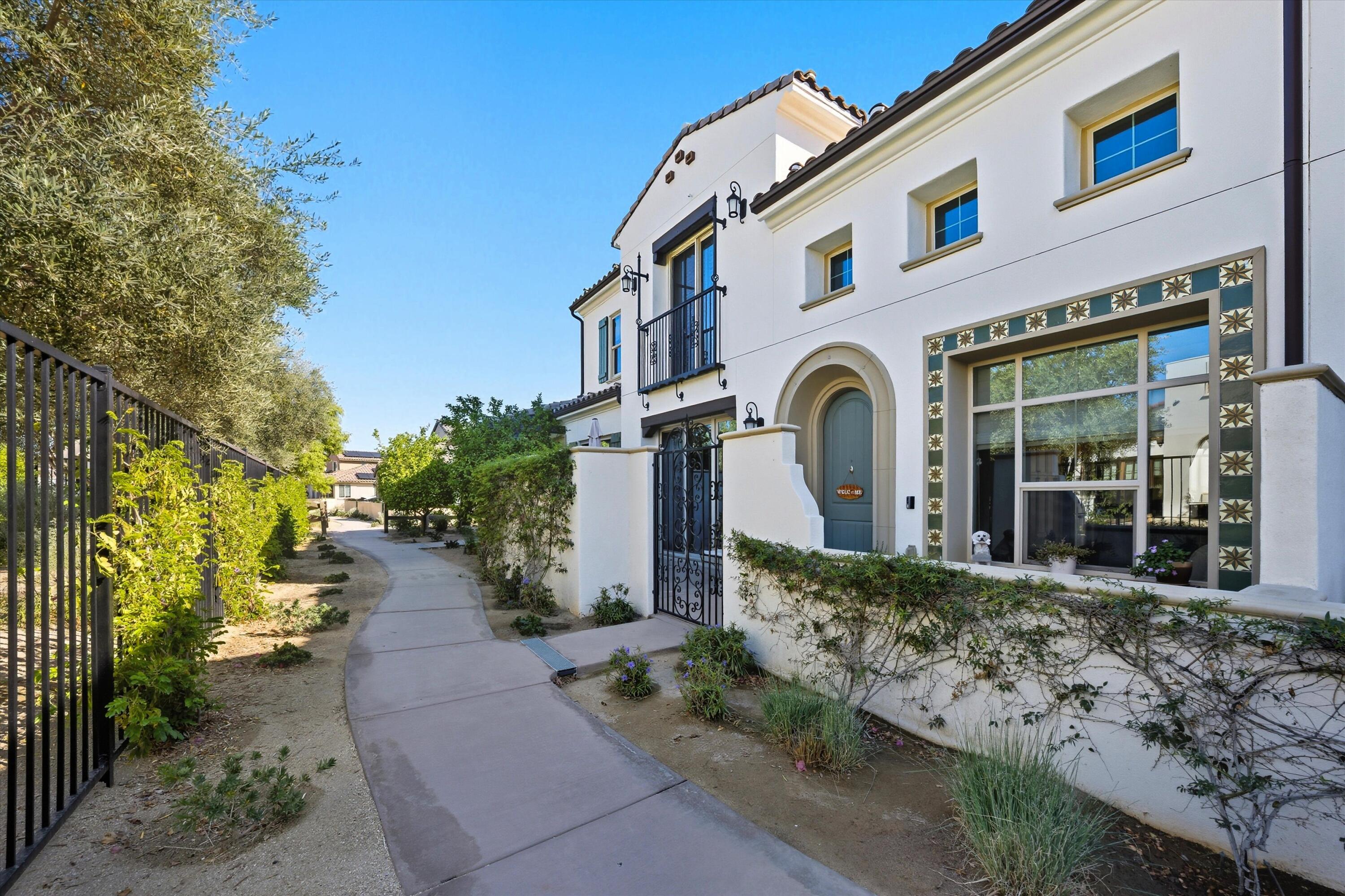 80256 Redstone Way, Unit V93 La Quinta, CA 92253 - Photo 3 of 37 a front view of a house with garden