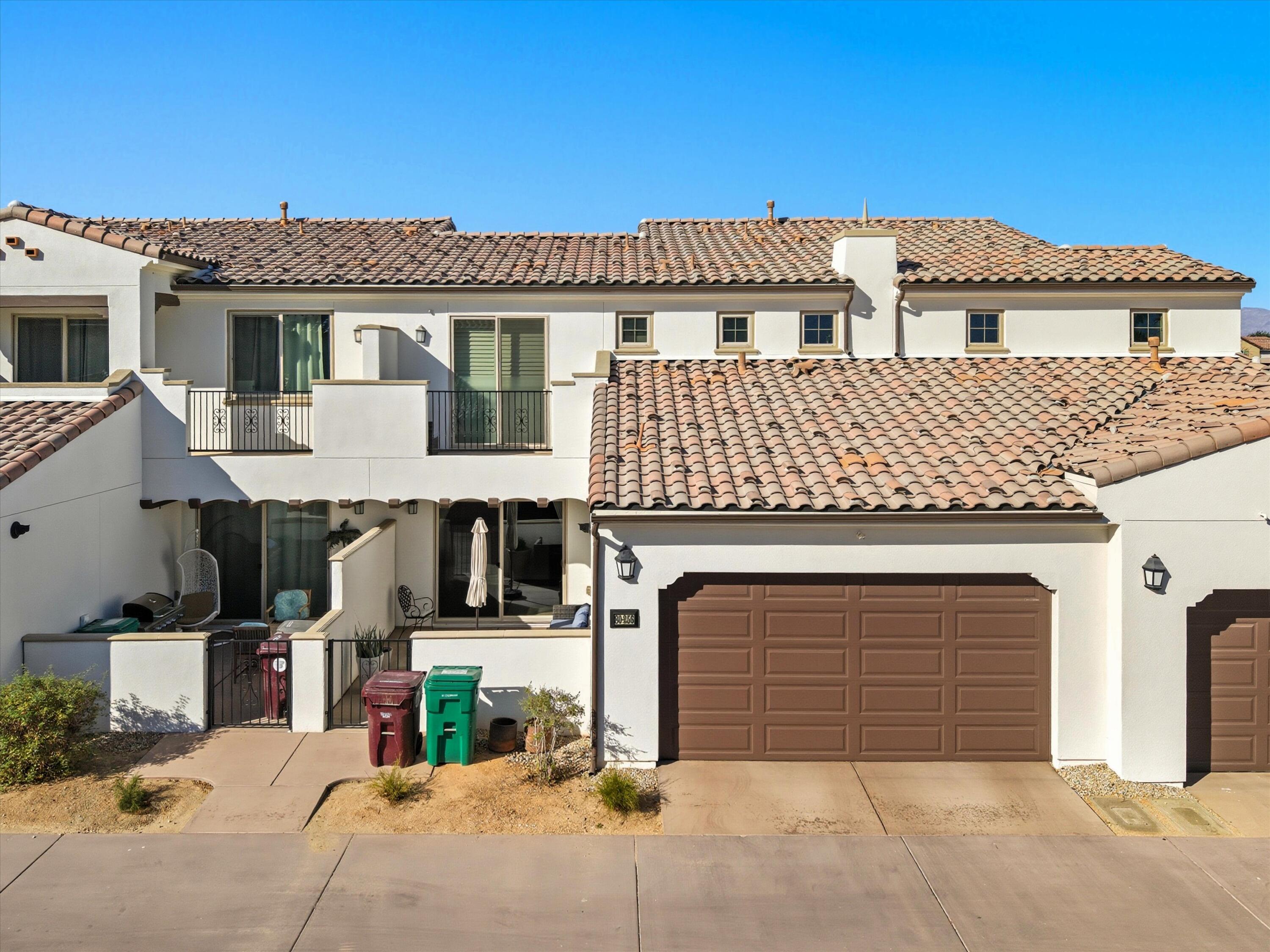 80256 Redstone Way, Unit V93 La Quinta, CA 92253 - Photo 36 of 37 a view of a white house with large windows