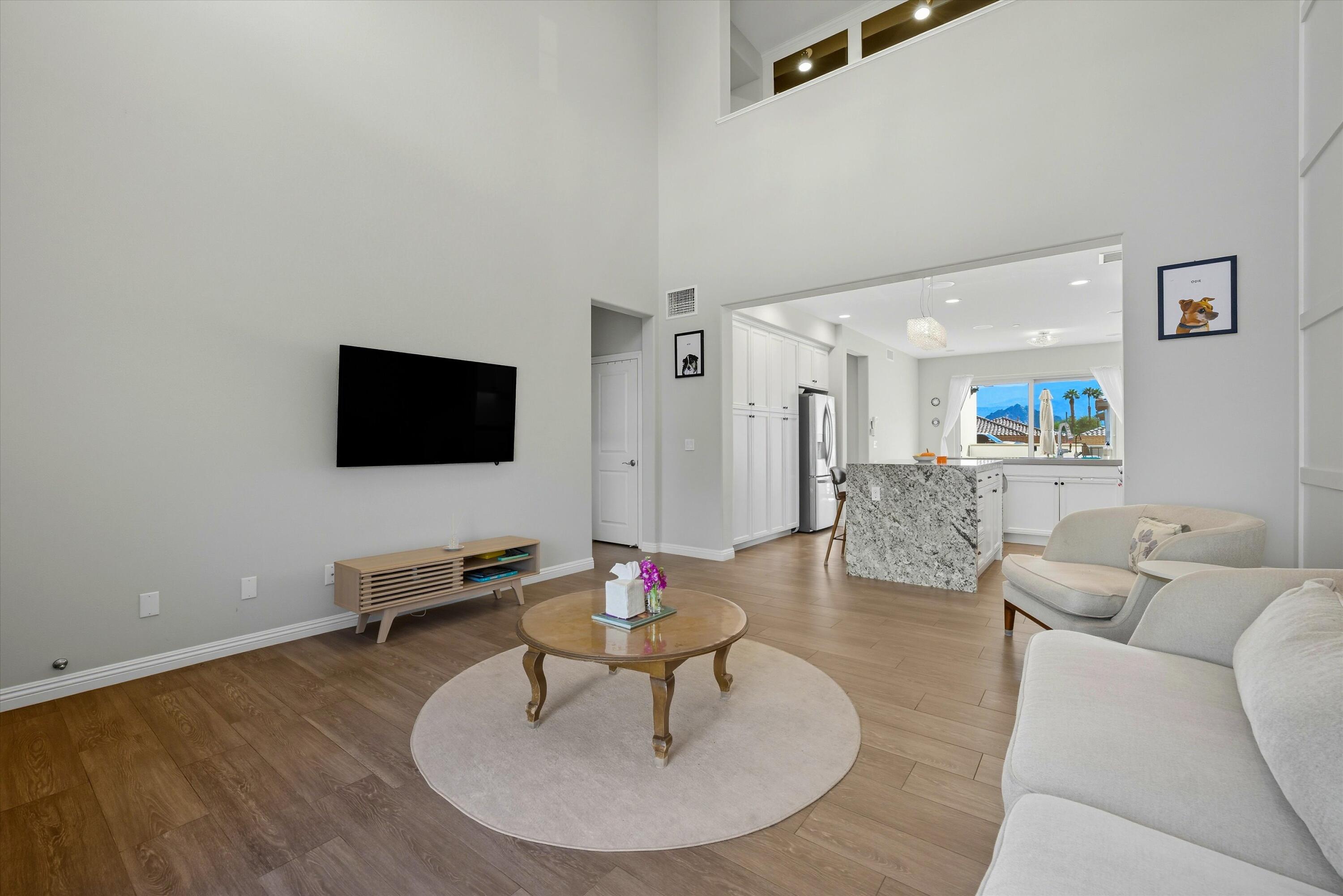 80256 Redstone Way, Unit V93 La Quinta, CA 92253 - Photo 9 of 37 a living room with furniture and a flat screen tv