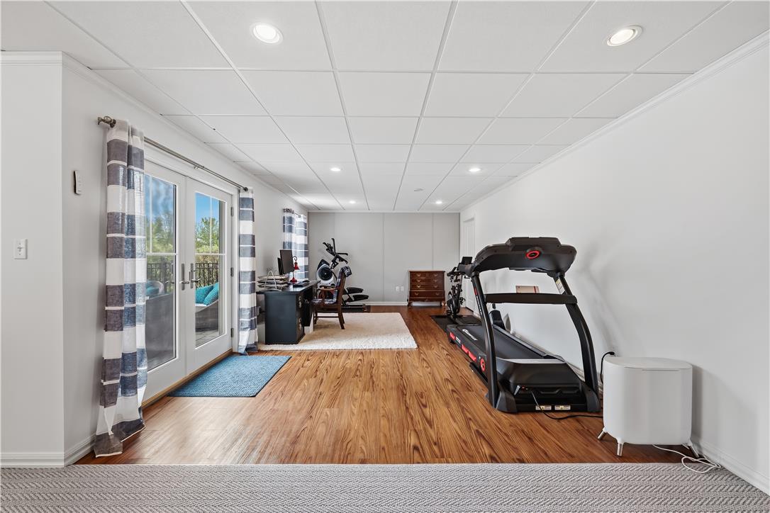 9031 Pathfinder Road Breinigsville, PA 18031 - Photo 52 of 63 A versatile recreation room features a walk-out patio and durable wood flooring.
