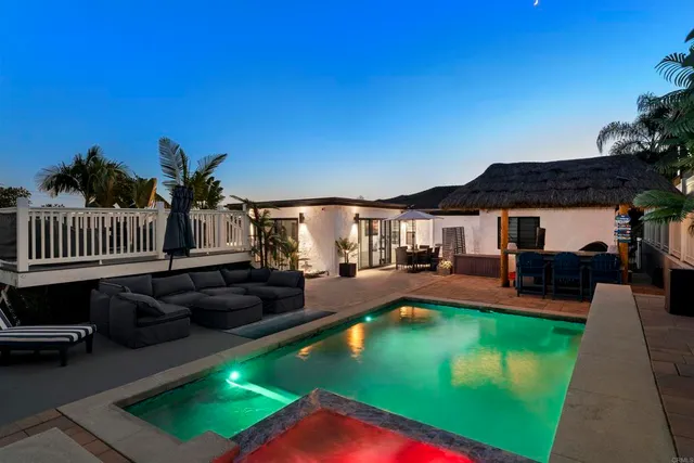 a view of a swimming pool with outdoor seating