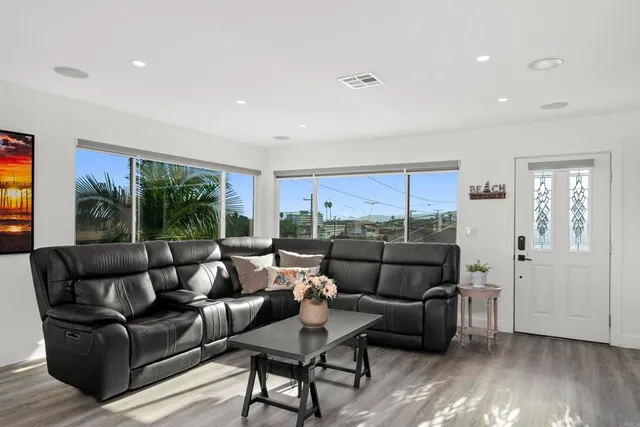 a kitchen with sink a refrigerator and wooden floor