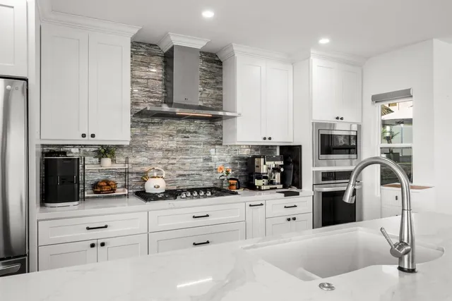 a bathroom with a glass shower door and a sink