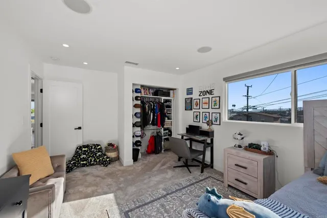 a view of a house with a yard and potted plants