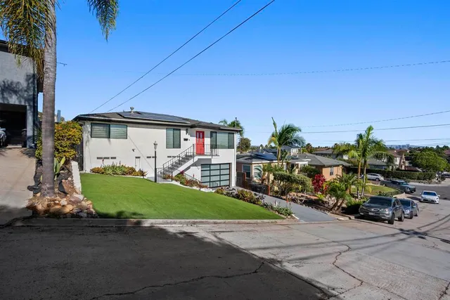 a view of house with yard and outdoor seating