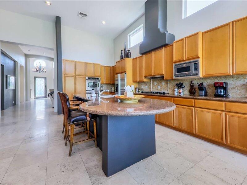 79995 Rancho La Quinta Drive La Quinta, CA 92253 - Photo 12 of 50 a kitchen with stainless steel appliances a sink counter top space cabinets and a window