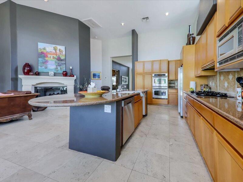 79995 Rancho La Quinta Drive La Quinta, CA 92253 - Photo 13 of 50 a large kitchen with stainless steel appliances kitchen island granite countertop a large counter top stainless steel appliances and cabinets
