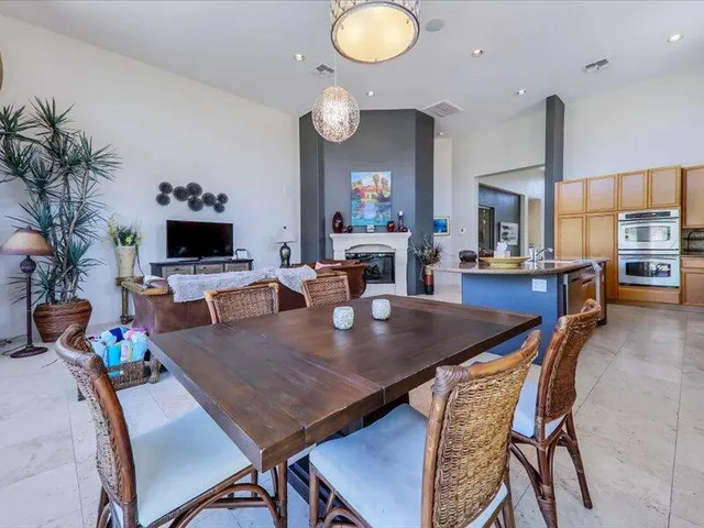 a dining hall with dining table and chairs