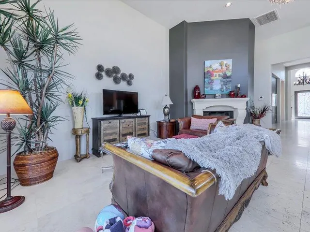 a living room with furniture fireplace and a large window