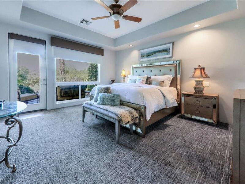 79995 Rancho La Quinta Drive La Quinta, CA 92253 - Photo 20 of 50 a spacious bedroom with a bed and a fireplace