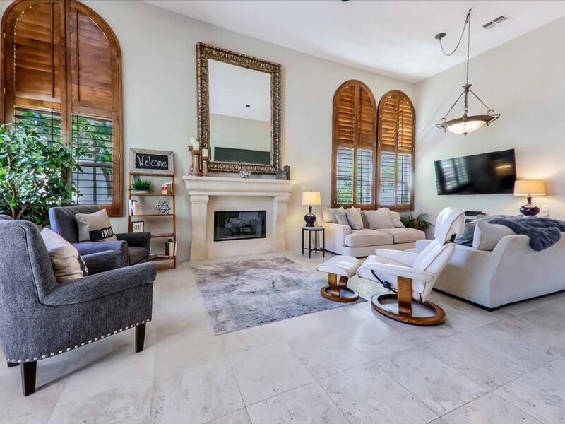79995 Rancho La Quinta Drive La Quinta, CA 92253 - Photo 2 of 50 a living room with furniture a fireplace and a flat screen tv