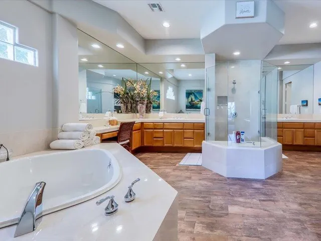 a bathroom with a tub and a shower