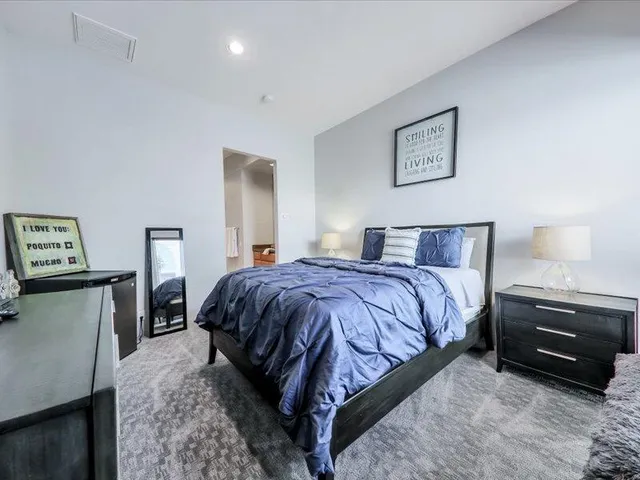 a bedroom with a bed and dresser