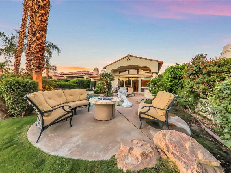 79995 Rancho La Quinta Drive La Quinta, CA 92253 - Photo 40 of 50 a view of a patio with table and chairs potted plants with wooden floor and fence