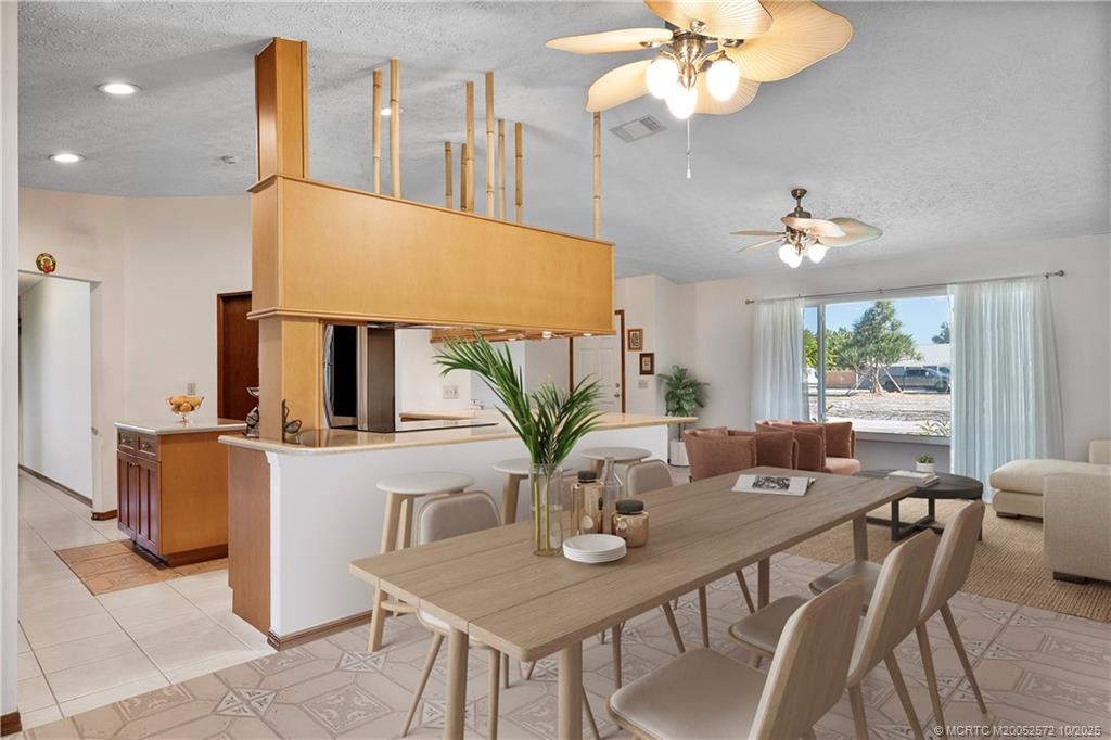5145 Southeast Matousek Street Stuart, FL 34997 - Photo 11 of 52 a view of a dining room with furniture and a chandelier