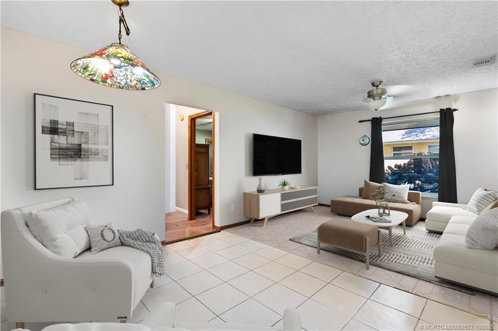5145 Southeast Matousek Street Stuart, FL 34997 - Photo 13 of 52 a living room with furniture and a flat screen tv