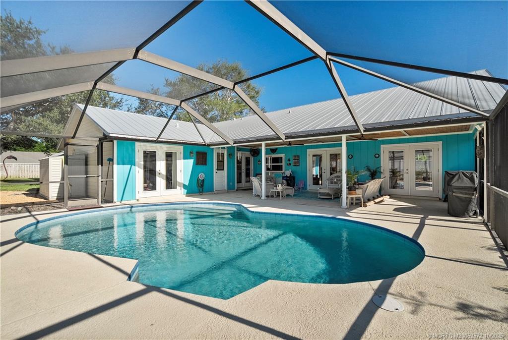 5145 Southeast Matousek Street Stuart, FL 34997 - Photo 27 of 52 a view of a swimming pool with sitting area