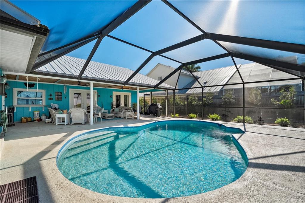 5145 Southeast Matousek Street Stuart, FL 34997 - Photo 28 of 52 a view of a swimming pool with a patio