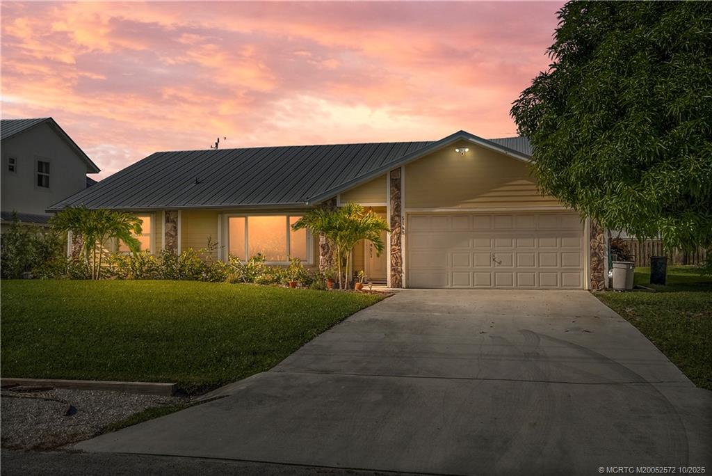 5145 Southeast Matousek Street Stuart, FL 34997 - Photo 3 of 52 a front view of a house with garden