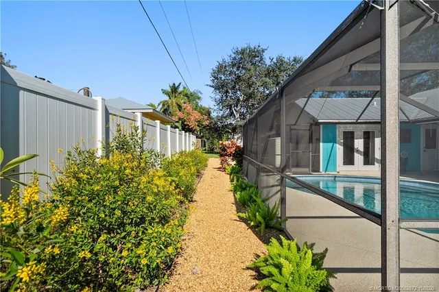 a front view of a house with a garden and plants