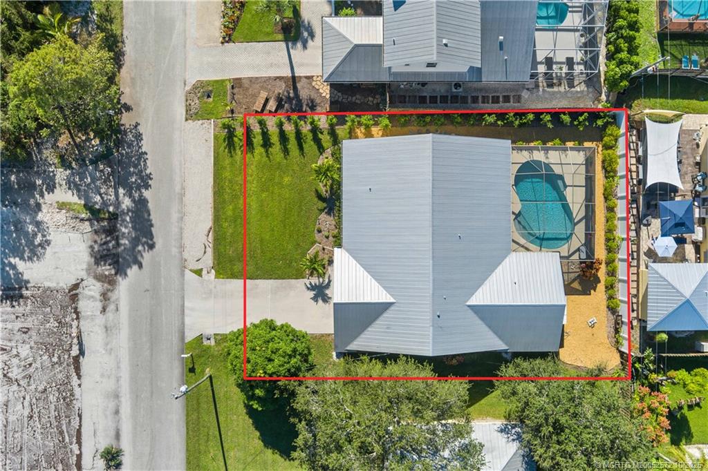 5145 Southeast Matousek Street Stuart, FL 34997 - Photo 37 of 52 an aerial view of a house with outdoor space pool patio area and seating area