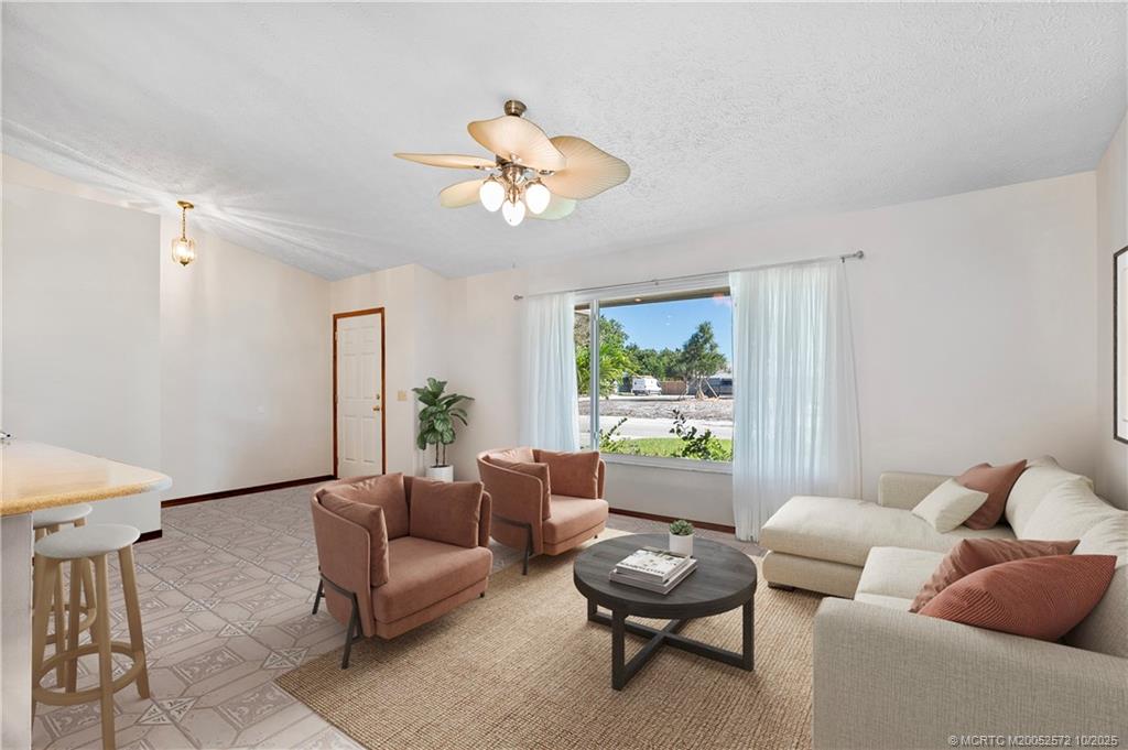 5145 Southeast Matousek Street Stuart, FL 34997 - Photo 5 of 52 a living room with furniture and a large window
