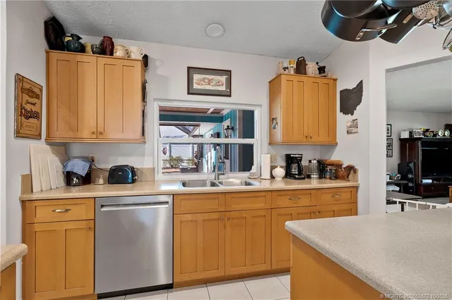 a kitchen with stainless steel appliances granite countertop a sink and cabinets