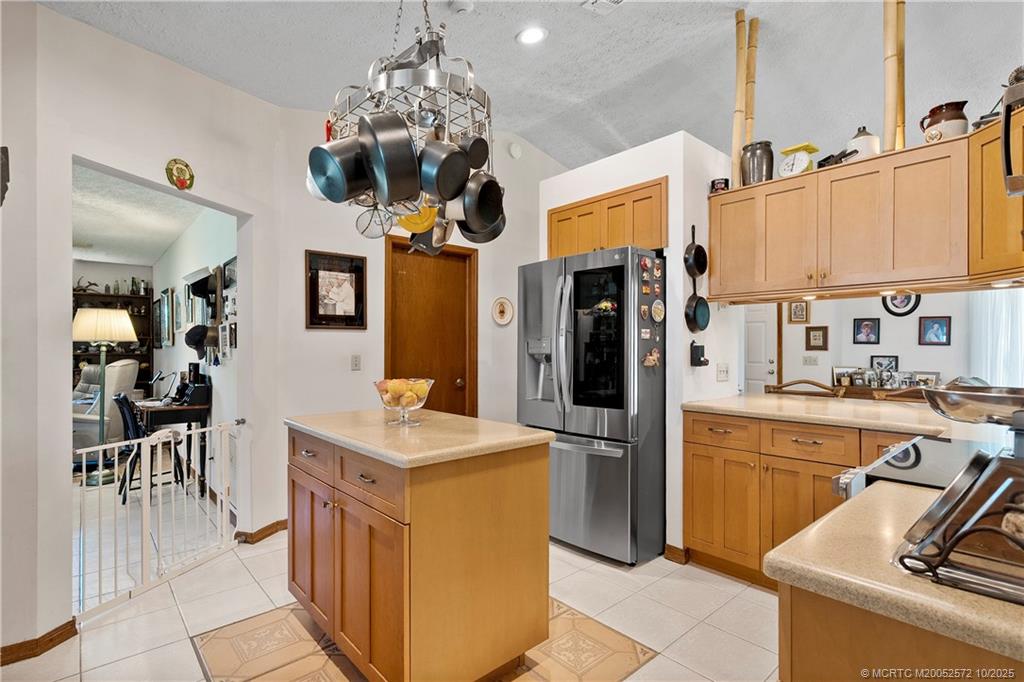 5145 Southeast Matousek Street Stuart, FL 34997 - Photo 10 of 52 a kitchen with stainless steel appliances granite countertop a sink a stove and a refrigerator