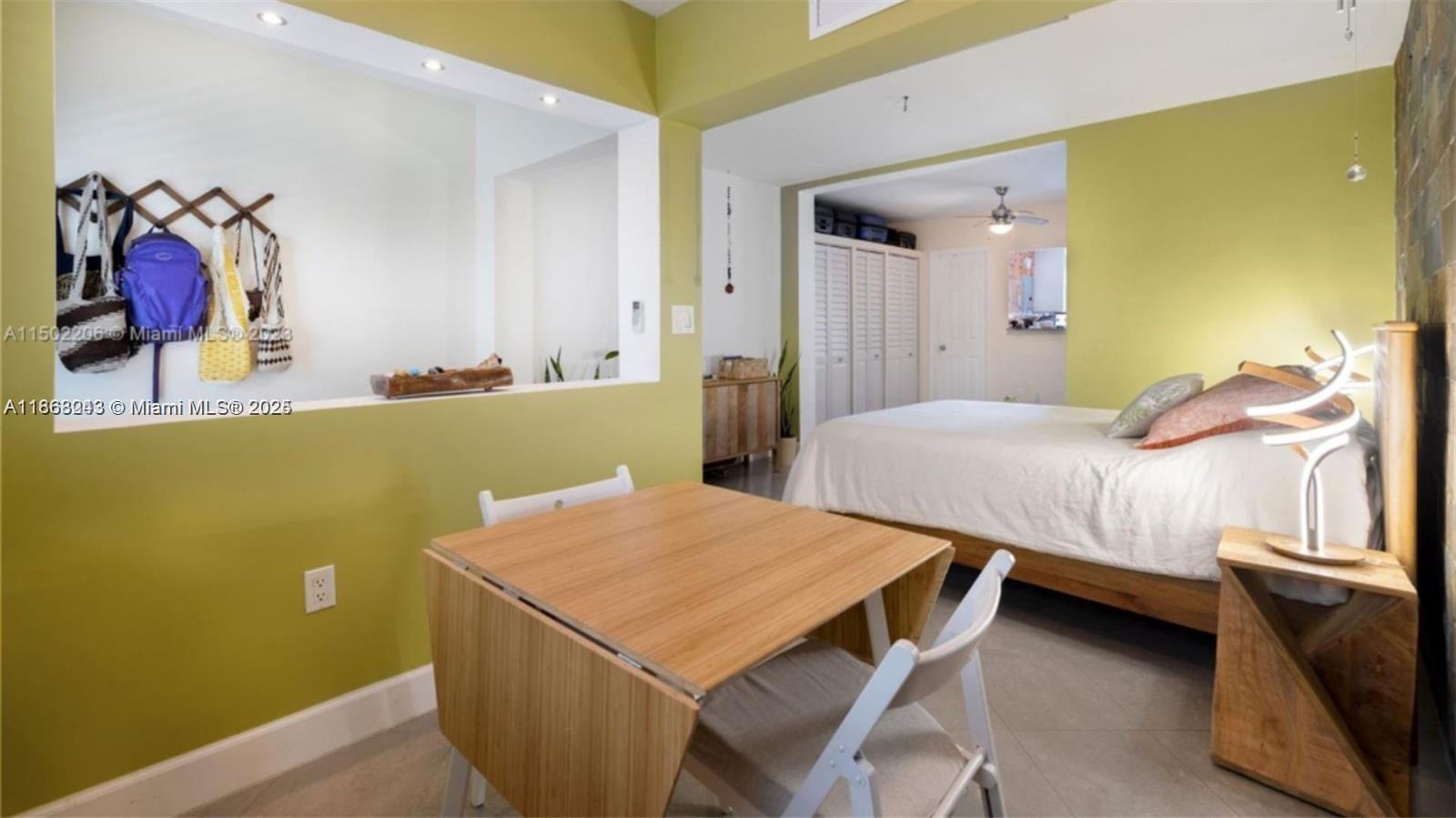 626 Meridian Avenue, Unit 5 Miami Beach, FL 33139 - Photo 12 of 19 a bedroom with a bed and a table in it