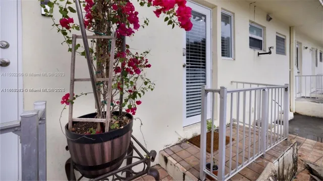 a view of a hallway and a dining room with furniture